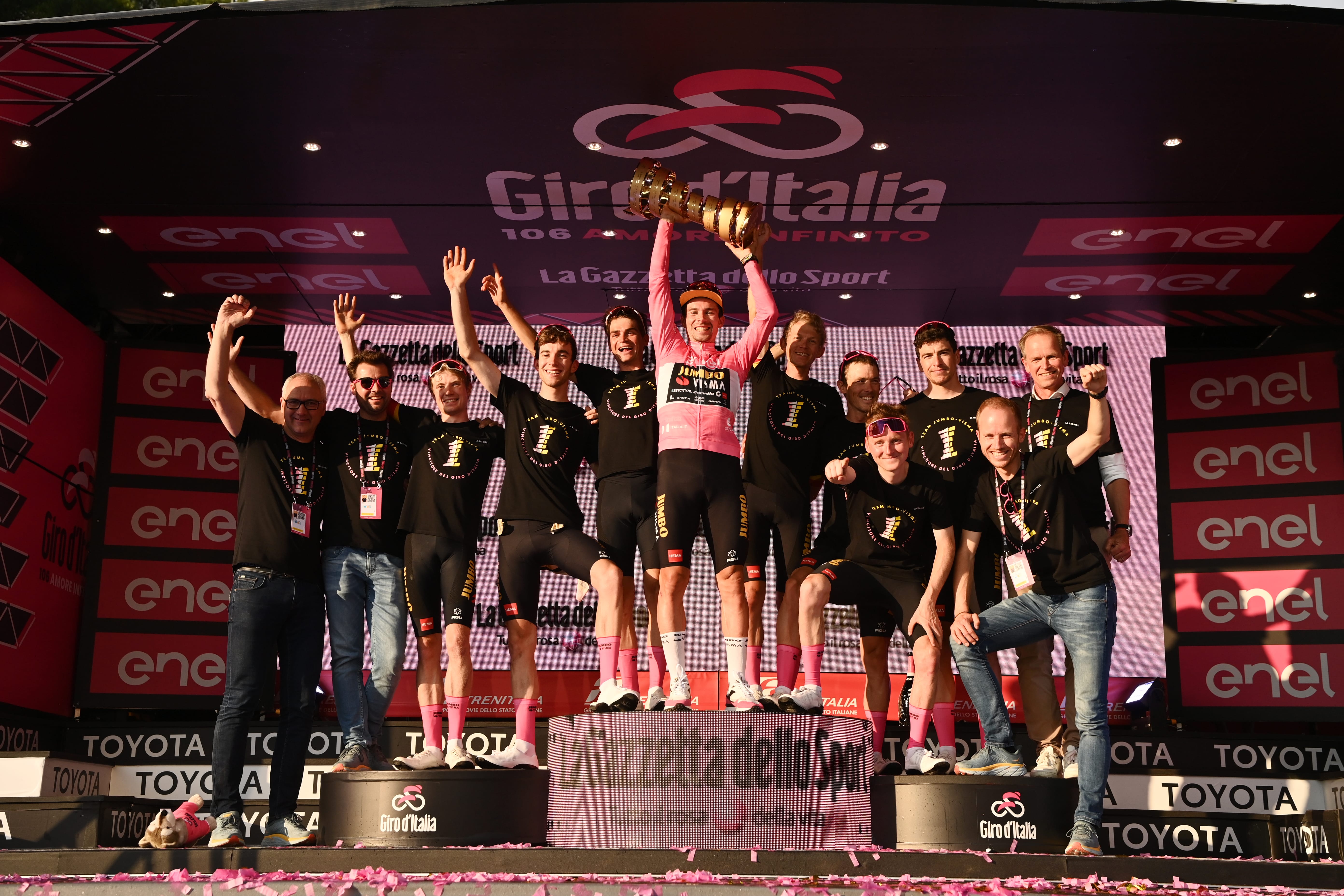 A team celebrates as they lift the Giro d'Italia trophy. Watch Giro d'Italia 2025 with Sportive Breaks