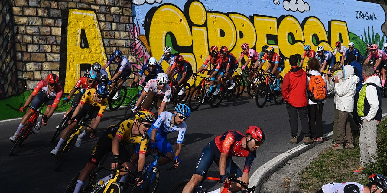 Riders take a tight hairpin bend, which you can witness in person during Milan Sanremo live