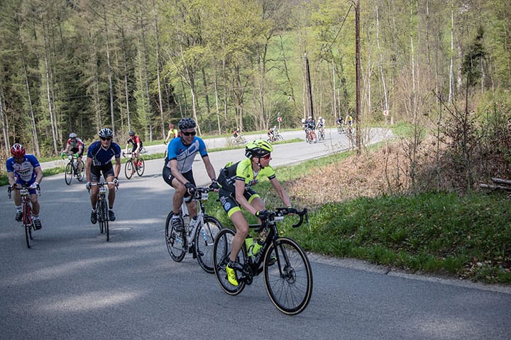 Riders travel through a bend during Liege Bastogne Liege 2025