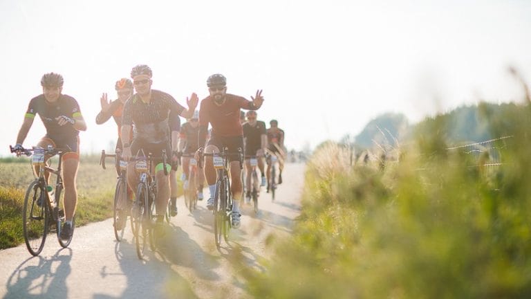 Riders pose to the camera as they take part in the Grand Depart 2025