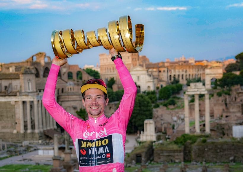 Roglic Primoz poses with his trophy in front of the 2024 Giro d'Italia hospitality provided by Team Visma Lease a Bike