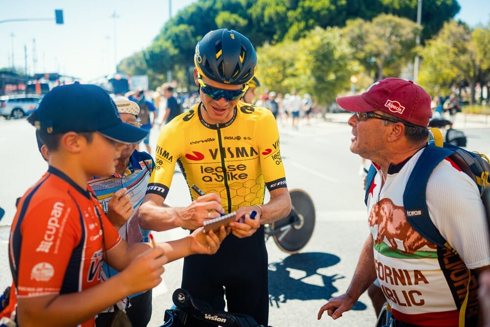 A Team Visma | Lease a Bike rider signs autographs during the Vuelta a Espana trip