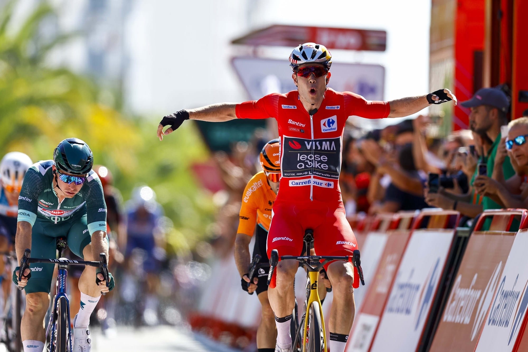 A rider celebrates winning a stage on the Vuelta a Espana trip