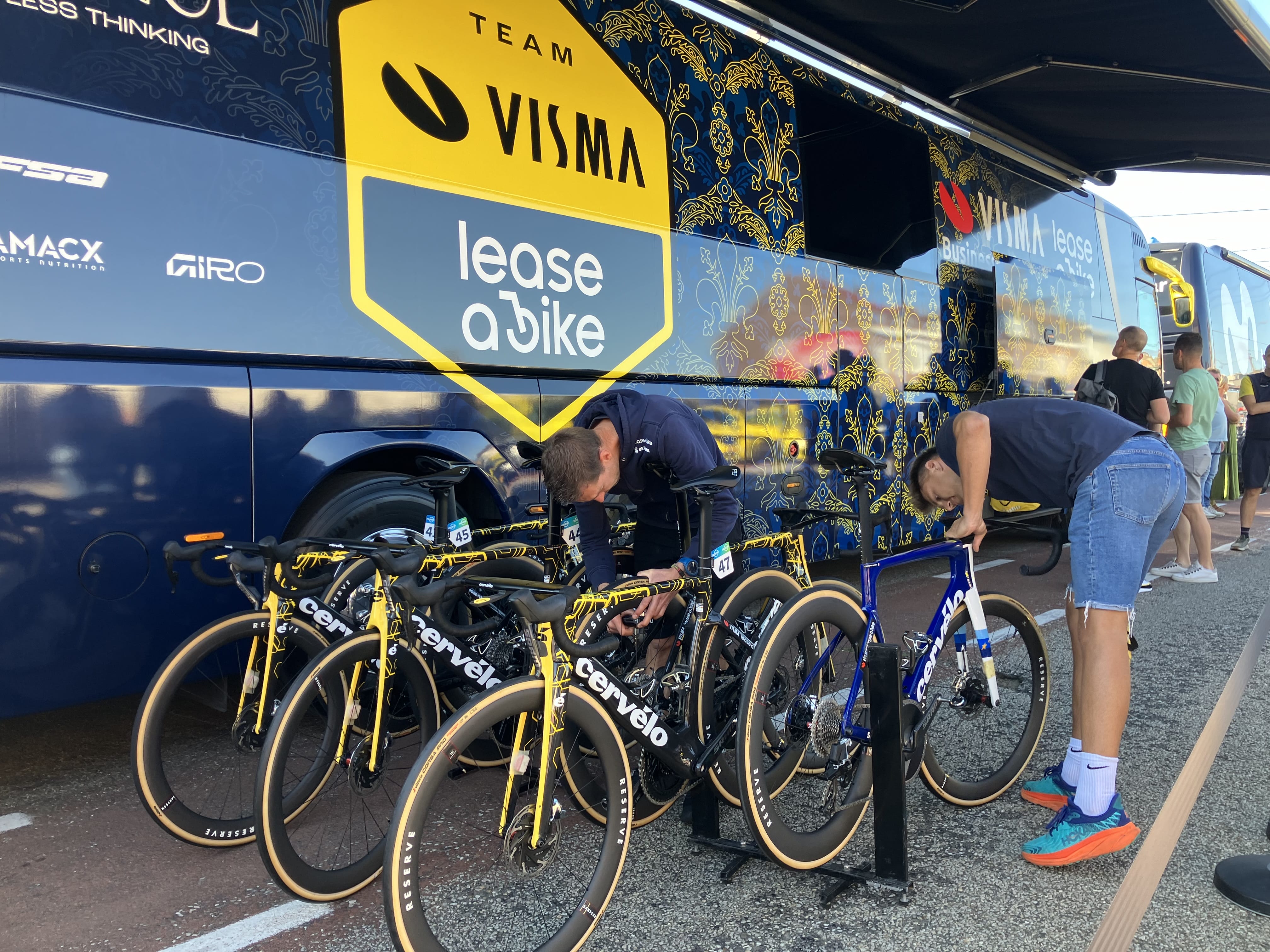 Mechanics fix bikes for Team Visma Lease a Bike ahead of the Renewi Tour