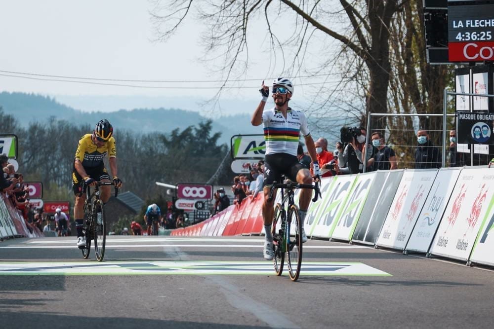 A rider celebrates after reaching the end of the Fleche Wallonne